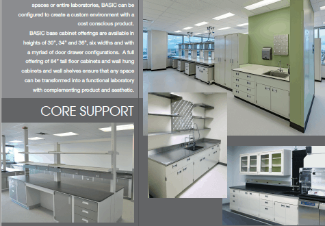 A laboratory with gray cabinets, green accents, and workstations with stools and equipment.